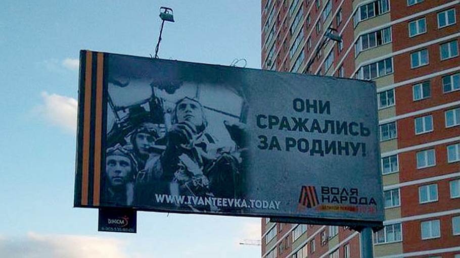 на рекламном баннере с надписью «Они сражались за родину!» рядом помещен снимок экипажа немецкого бомбардировщика Junkers 88.
